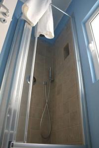 a bathroom with a shower with a shower head at La Casetta 19 in Polignano a Mare