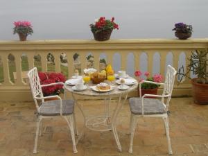 una mesa con dos sillas y una mesa con comida. en Mar i Vent, en Banyalbufar