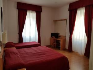 Voodi või voodid majutusasutuse Hotel L'Isola toas