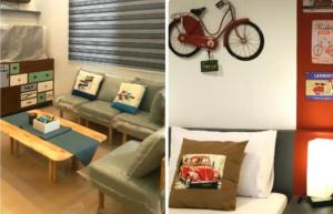 uma sala de estar com um sofá e uma bicicleta na parede em Bayview Country Inn El Nido em El Nido
