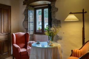 a living room with a table and a chair and a window at Hotel Akerreta in Akerreta
