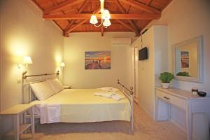 a bedroom with a bed and a wooden ceiling at Ktima Kehrioti in Panormos Skopelos