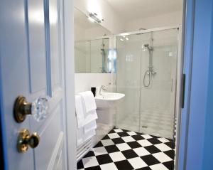 a bathroom with a shower and a sink and a toilet at Crystal Suites Chez Helena in Krakow