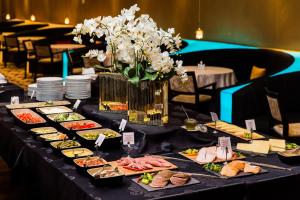 a table topped with plates of food on top at Original Sokos Hotel Viru in Tallinn