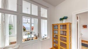 a room with windows and a door with a table at Villa Carola - 100 m zum Strand in Bansin +51 photos