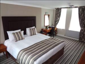 a hotel room with two beds and a large window at Aston Court Hotel in Derby