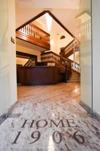a room with stairs and a sign that says home at Willa Home in Ciechocinek