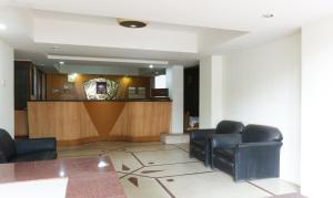 a waiting room with leather chairs and a counter at Itsy By Treebo - Hill View Ex in Pune