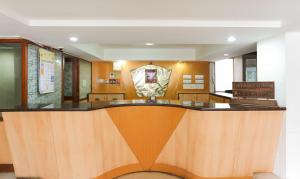 a lobby with a reception desk in a building at Itsy By Treebo - Hill View Ex in Pune