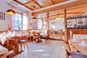 a restaurant with wooden ceilings and tables and chairs at Bavaria Hotel Münchner Hof Superior in Stuttgart