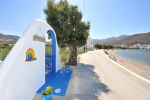 a small house on the side of a beach at Pension Titika in Katapola