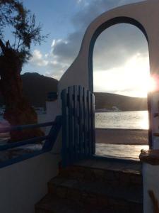 a view of the ocean from a building with a window at Pension Titika in Katapola