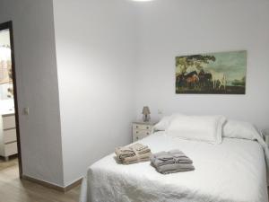 a bedroom with a bed with two towels on it at Chalet en Roche in Conil de la Frontera +65 photos