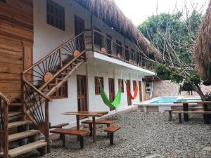 a building with stairs and benches next to a pool at Hostal Nibuni Palomino in Palomino