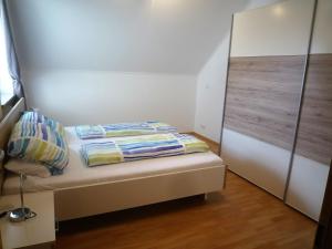 Dormitorio pequeño con cama y armario en "Villa Sabine", en Waidhaus