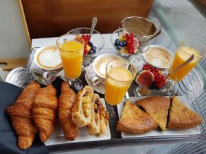 a tray of breakfast foods and drinks on a table at Althea Inn Roof Terrace in Rome