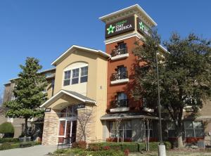 a building with a sign on top of it at Extended Stay America Suites - Dallas - Plano in Plano