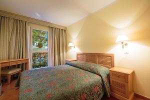 a hotel room with a bed and a window at Apartments Bellevue Plava Laguna in Poreč