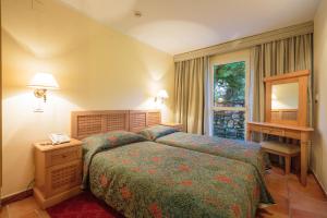 a hotel room with a bed and a window at Apartments Bellevue Plava Laguna in Poreč +37 photos
