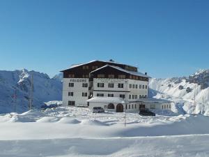 a large building on top of a snow covered mountain at Hotel Folgore in Passo Stelvio