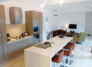 a kitchen and living room with a sink and a counter at Baan Tai Tara 4 in Ban Tai