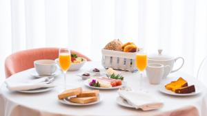 a table topped with plates of food and drinks at Art Senses | Suites & Rooms in Porto