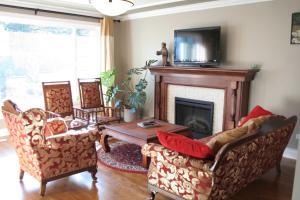 a living room with two chairs and a fireplace at Semi Centre House in White Rock
