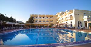 a large swimming pool in front of a hotel at Kouros Hotel in Drama