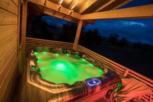 a hot tub on the back porch of a cabin at The Lodges at Artlegarth in Ravenstonedale