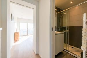 a bathroom with a shower and a glass door at Apartment Sea View in Middelkerke