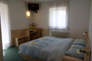 Postel nebo postele na pokoji v ubytování Hotel Zanon