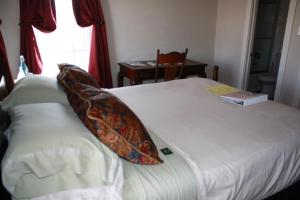 Postel nebo postele na pokoji v ubytování Woodrow House Bed & Breakfast