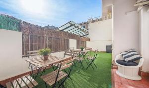 a patio with tables and chairs on a balcony at You Stylish El Borne Apartments in Barcelona