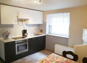 a small kitchen with a stove and a sink at Worker Apartment Hohenstadt in Hohenstadt