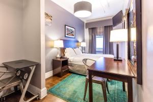 a hotel room with a bed and a desk and a table at Hotel 309 in New York