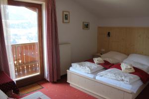 a bedroom with a bed and a large window at Bauernhof Grussberggut in Bad Hofgastein