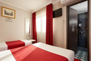 Letto o letti in una camera di Grand Hôtel Amelot