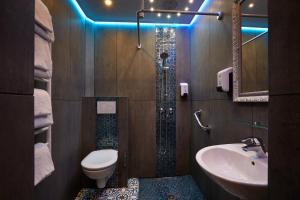 a bathroom with a shower with a toilet and a sink at Grand Hôtel Amelot in Paris