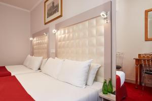 Letto o letti in una camera di Grand Hôtel Amelot