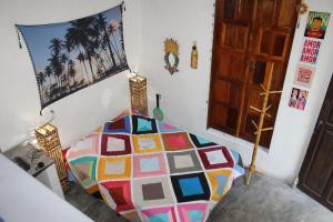 ボイペバ島にあるCamping & Hostel Flor Do Cerradoのカラフルなベッドが備わるベッドルーム1室が備わります。
