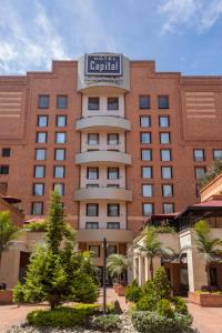 a large red brick building with a sign on it at GHL Hotel Capital in Bogotá