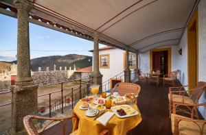 a table with food on top of a balcony at Casa da Portela de Sampriz in Ponte da Barca
