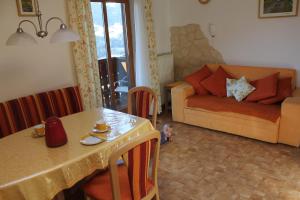 a living room with a table and a couch at Bauernhof Grussberggut in Bad Hofgastein