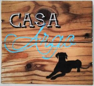 a painting of a dog on a wooden sign at Casa Argo in antico borgo medievale in Borgo a Buggiano