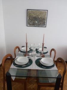 a dining room table with two candles on it at Apartamento Ayuntamiento in Logroño