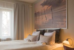 a bedroom with a large bed with two pillows at Borent Suite Apartment in Turku