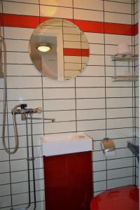 a bathroom with a toilet and a sink and a mirror at Solsta Hotell in Karlstad