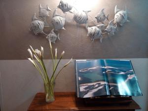 a vase on a table with a book and a vase at Hotel Telenia in Lido di Jesolo