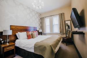 Un pat sau paturi într-o cameră la The Duke of Edinburgh Hotel & Bar