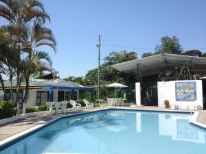 a swimming pool with chairs and a building at Hotel Villa Paz in San Francisco